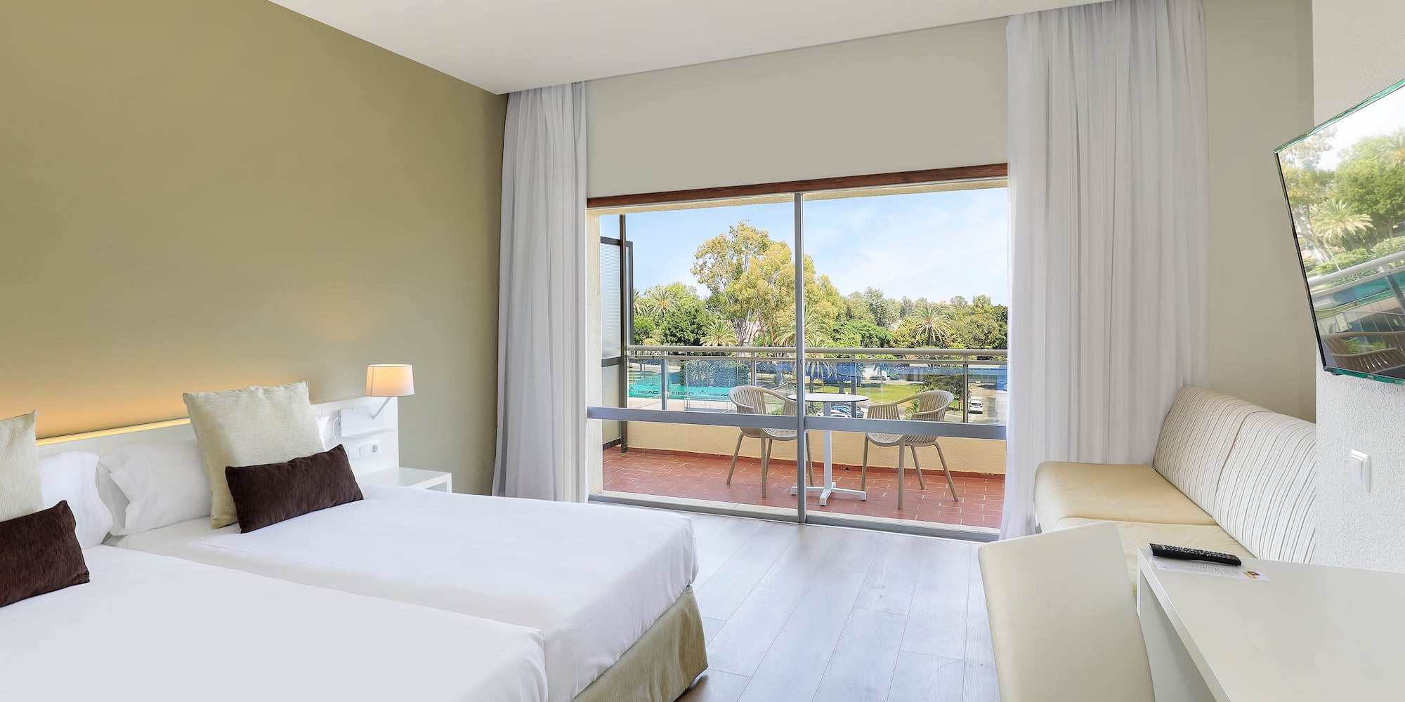 a room with two beds and a glass door