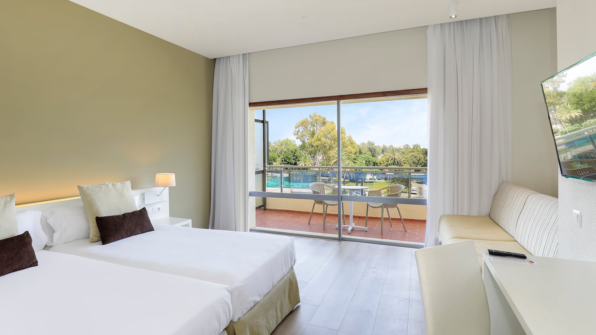 a room with two beds and a glass door