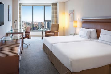 a hotel room with two beds and chairs