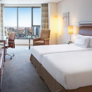 a hotel room with two beds and chairs