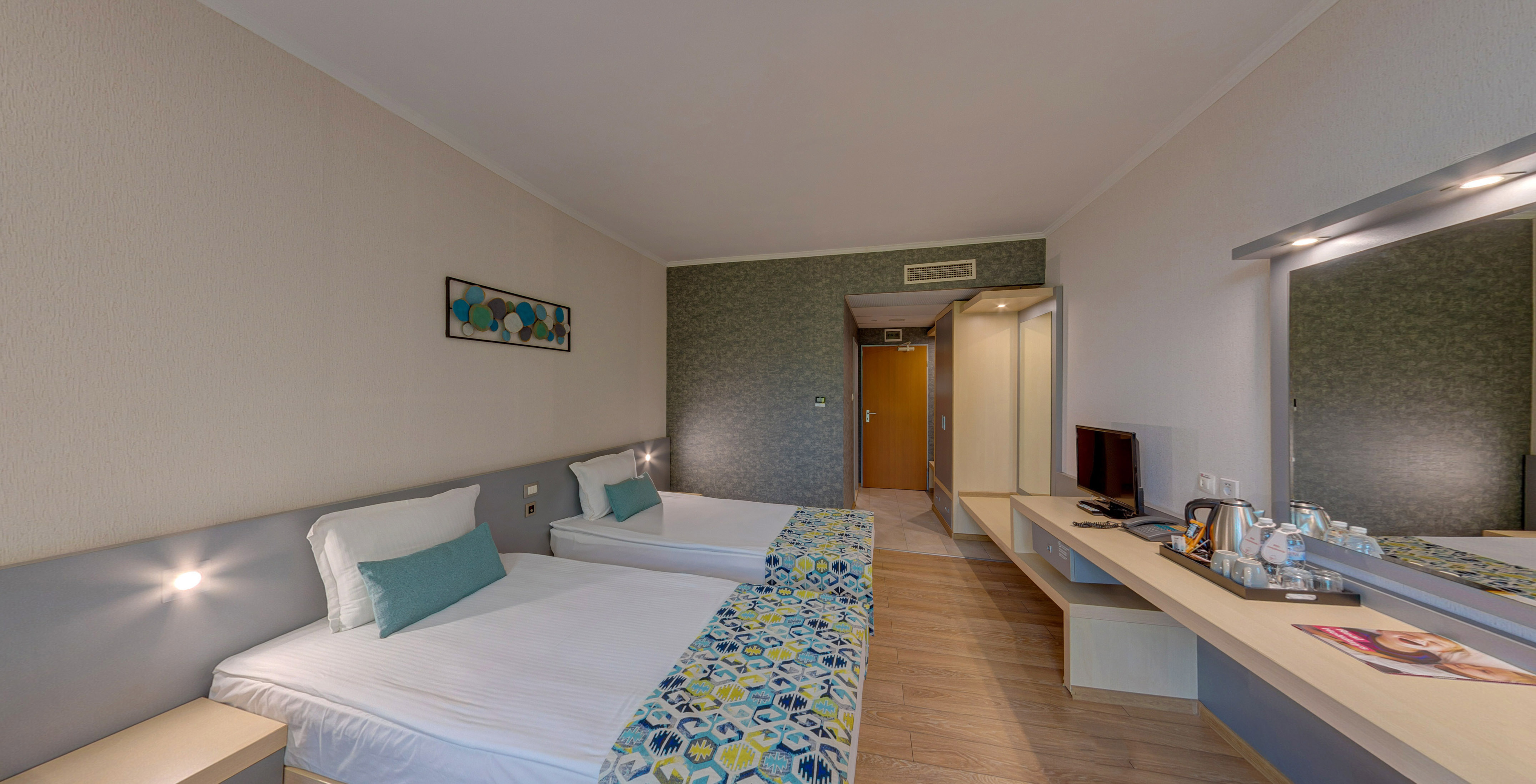 a room with two beds and a television