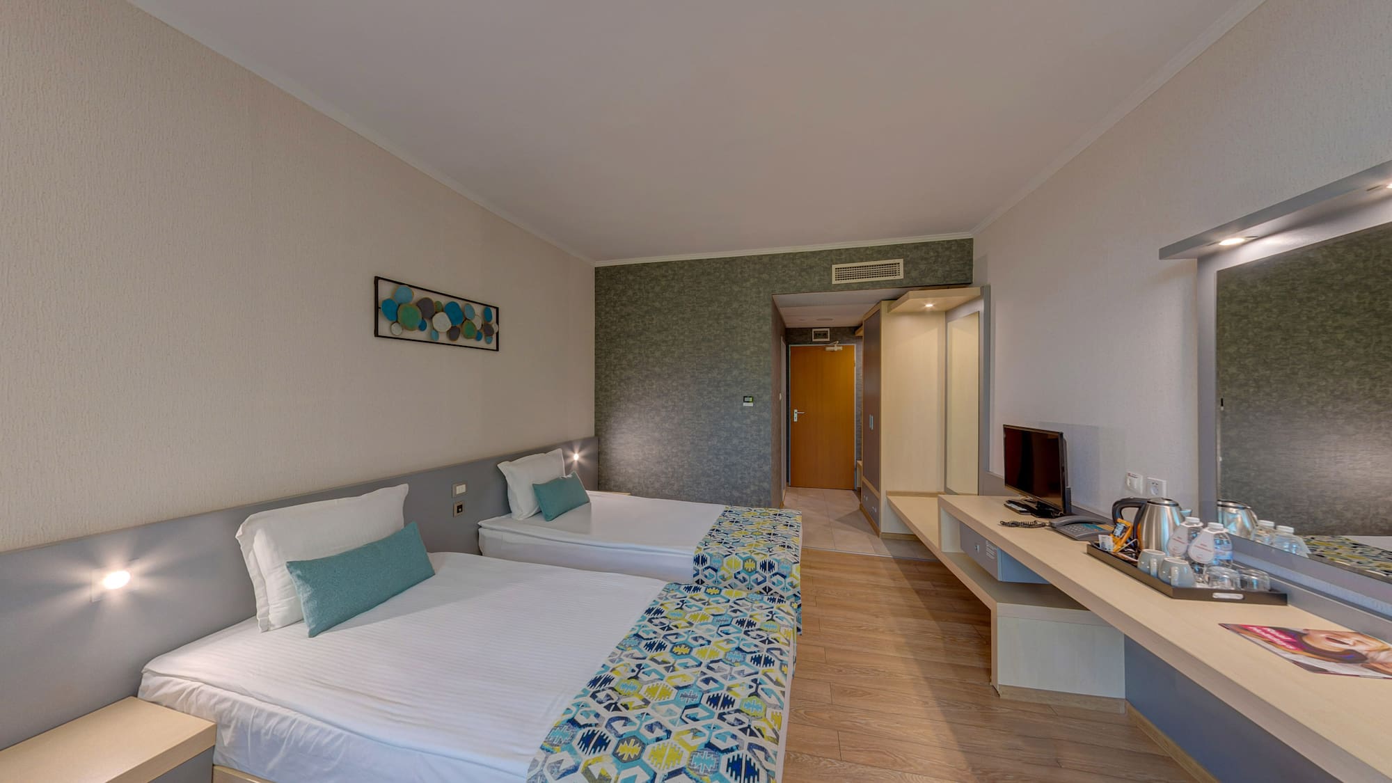 a room with two beds and a television