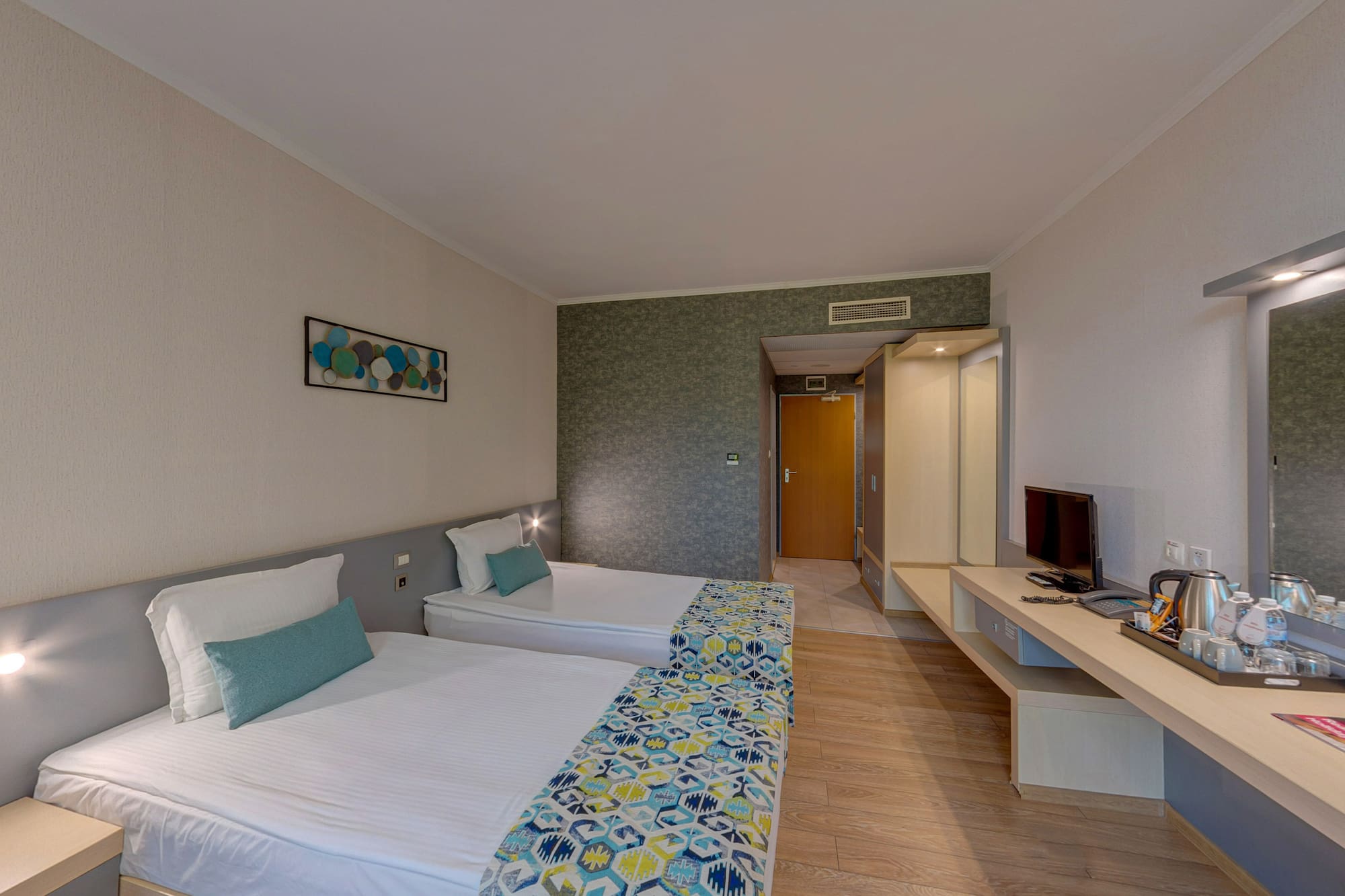 a room with two beds and a television