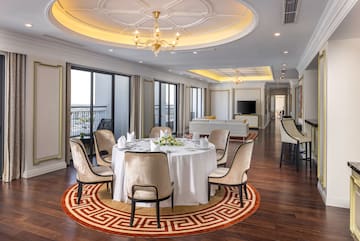 a room with a round table and chairs