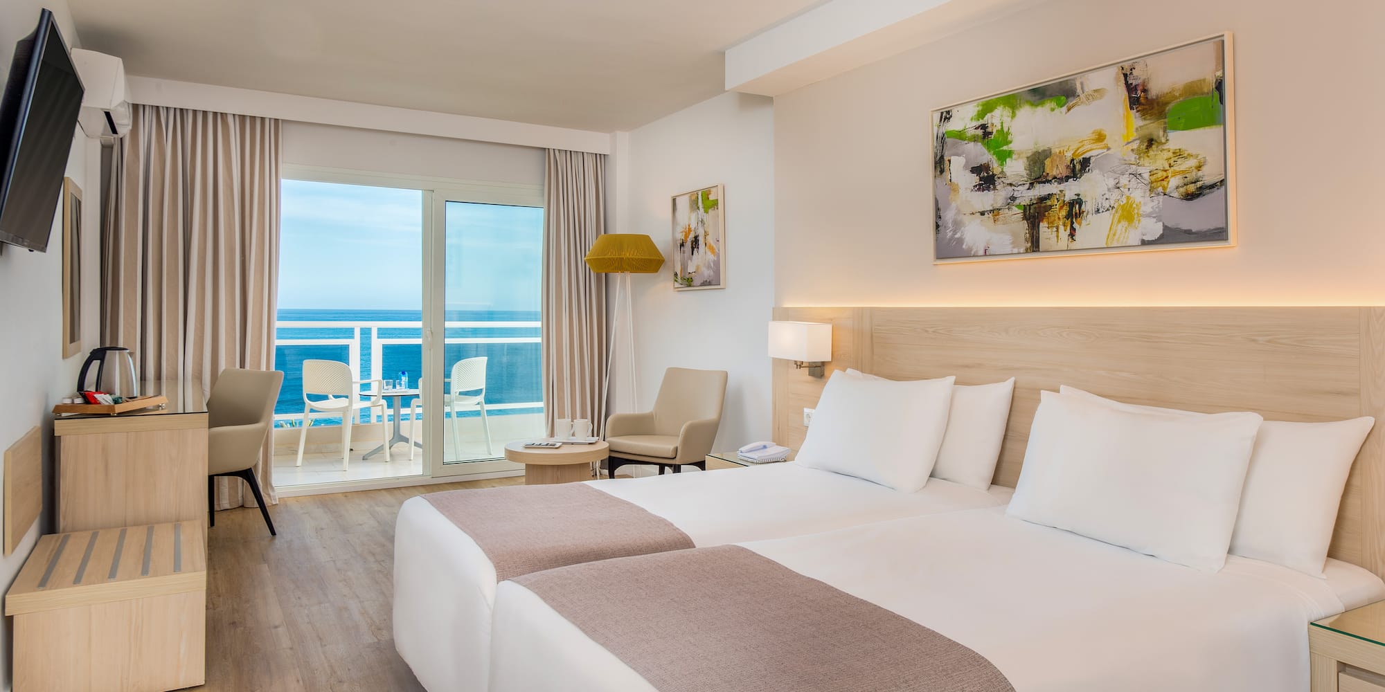 a room with two beds and a glass door