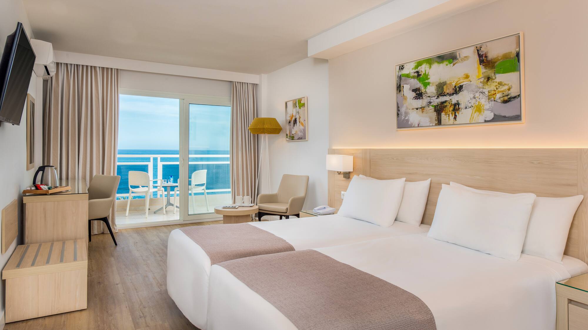 a room with two beds and a glass door