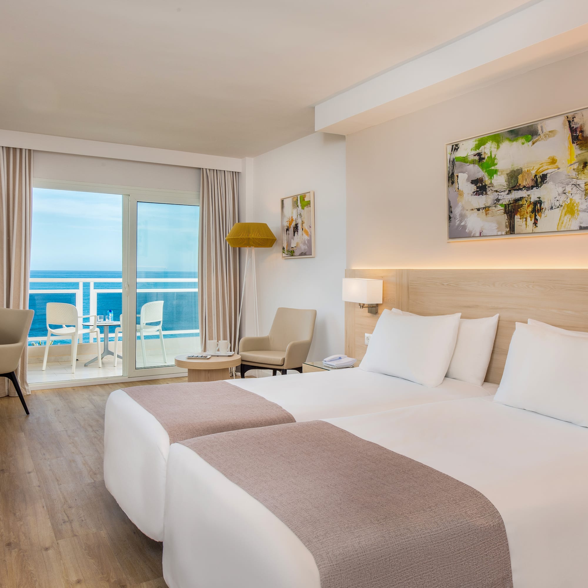 a room with two beds and a glass door