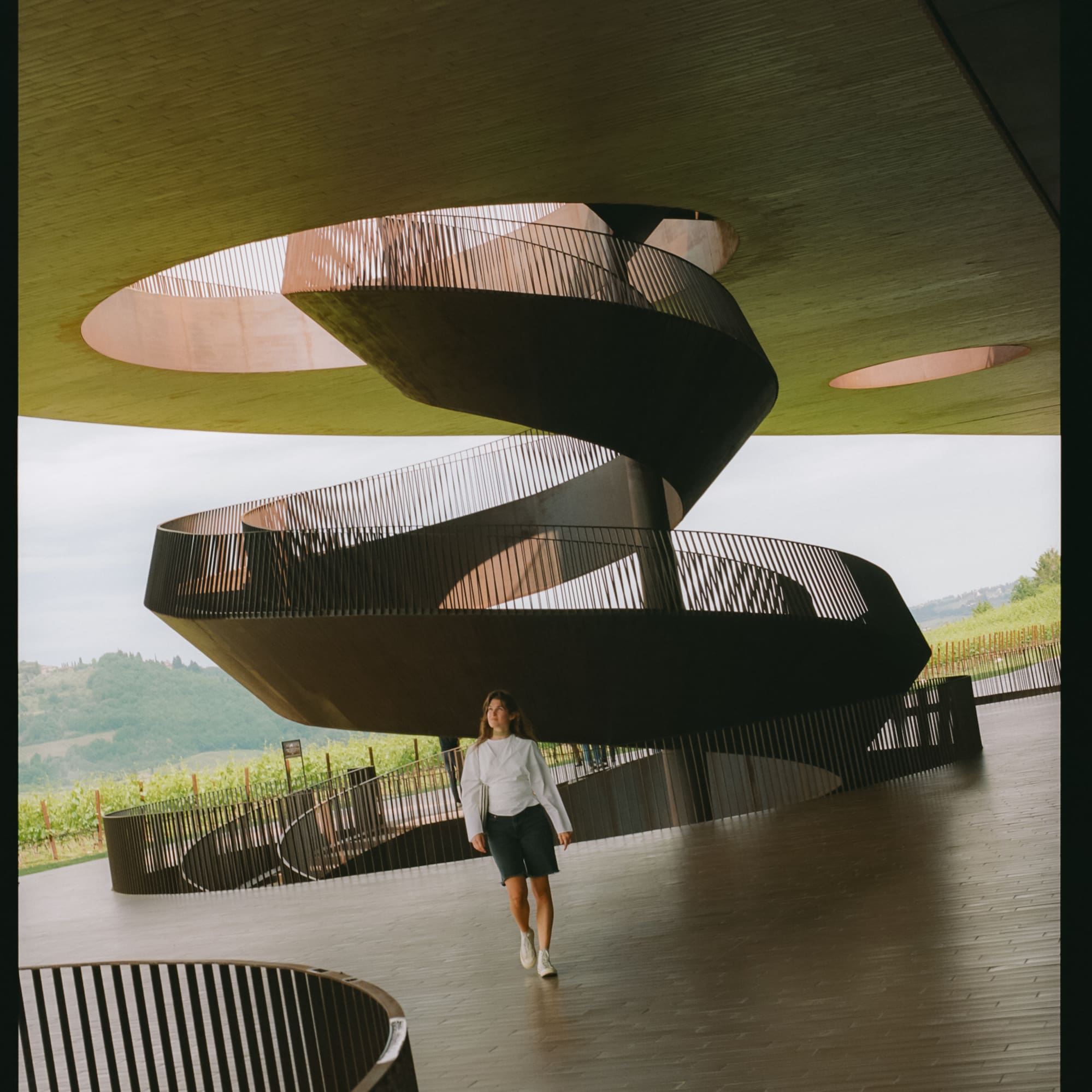 a woman walking in a spiral staircase