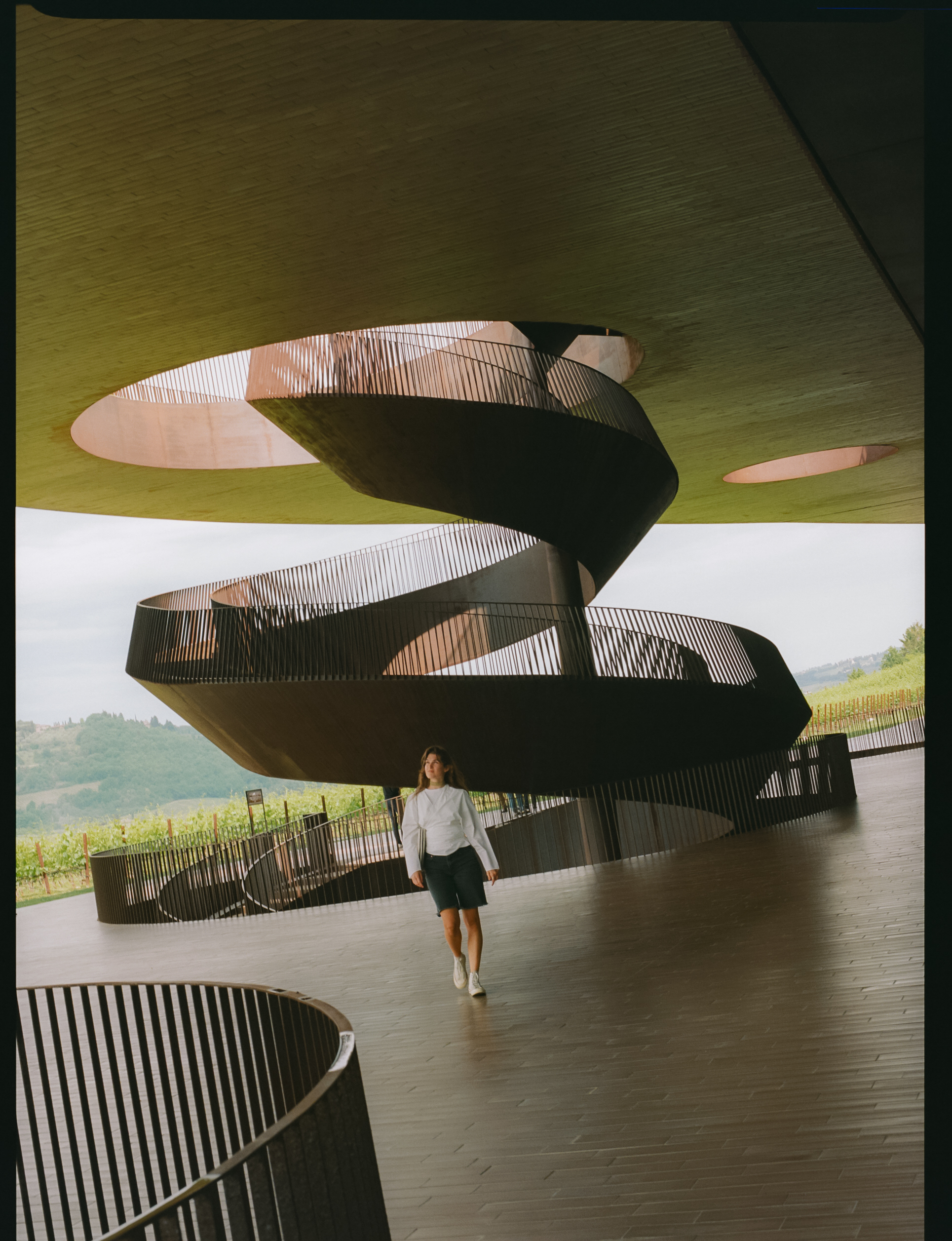 a woman walking in a spiral staircase