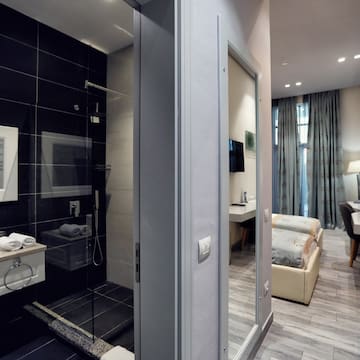 a bathroom with a shower and a bed
