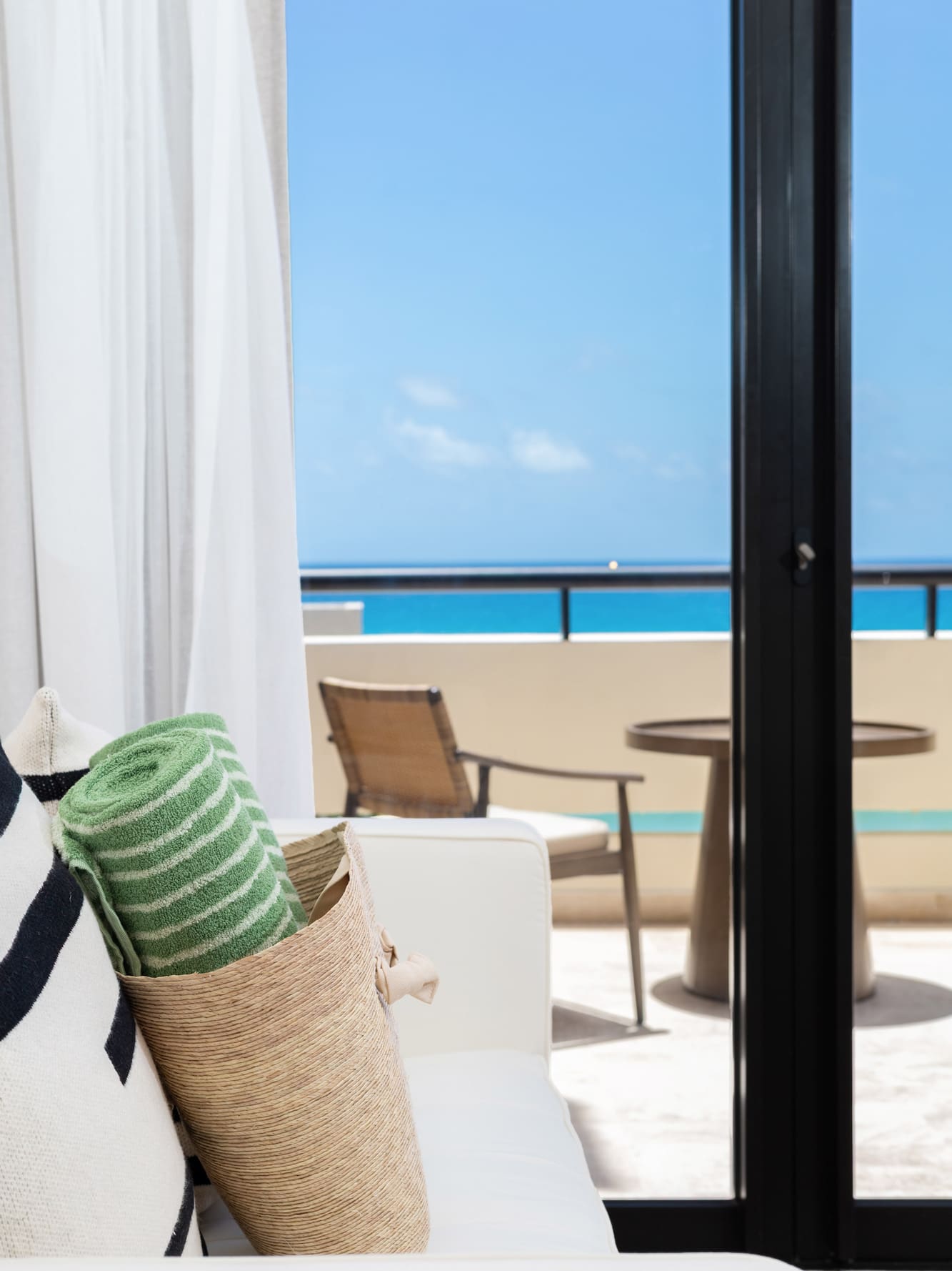 a beach towel and a bag on a couch