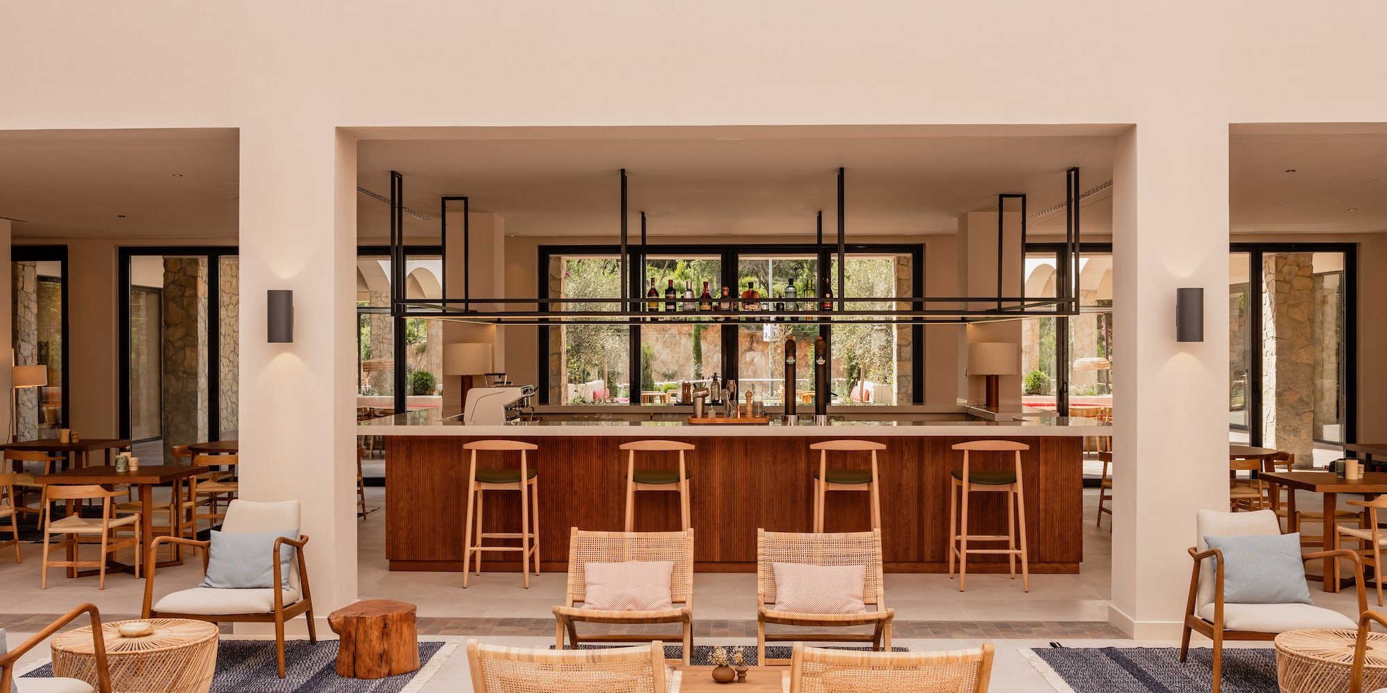 a room with a bar and chairs.