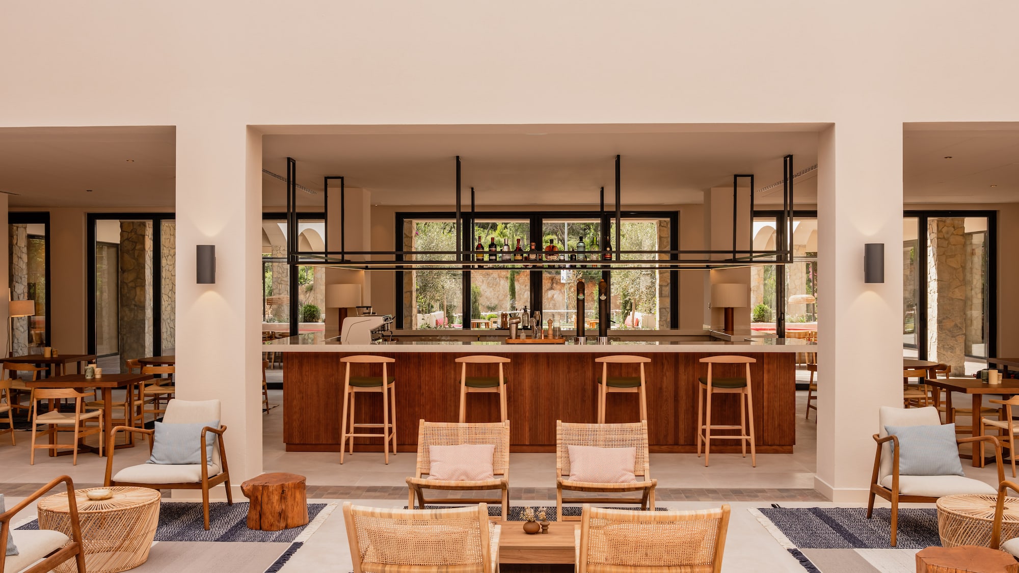 a room with a bar and chairs.