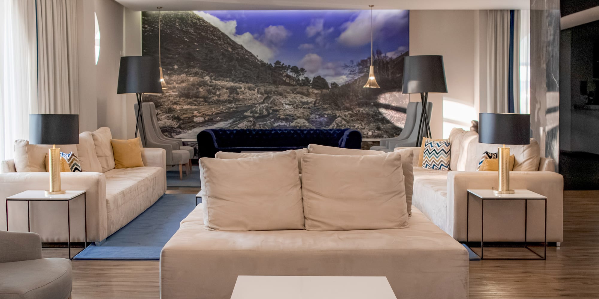 a room with couches and a large picture on the wall