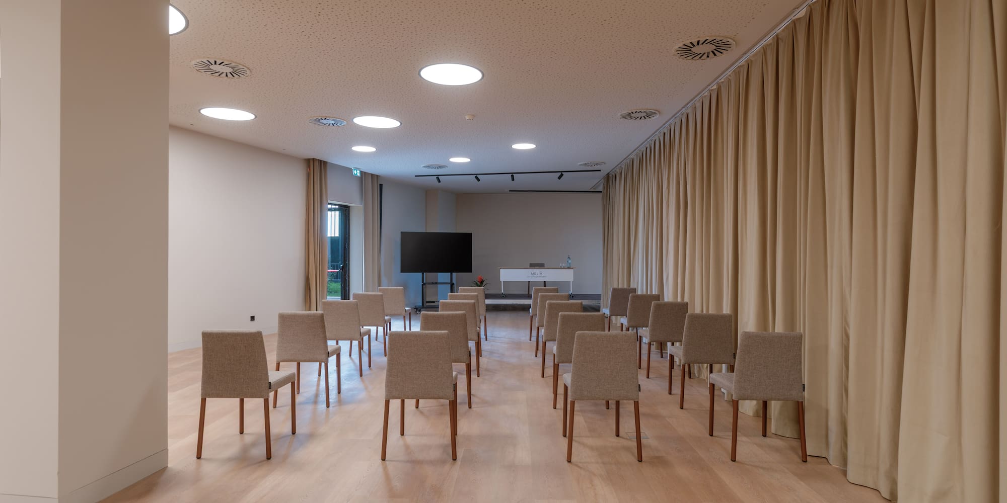 a room with chairs and a television