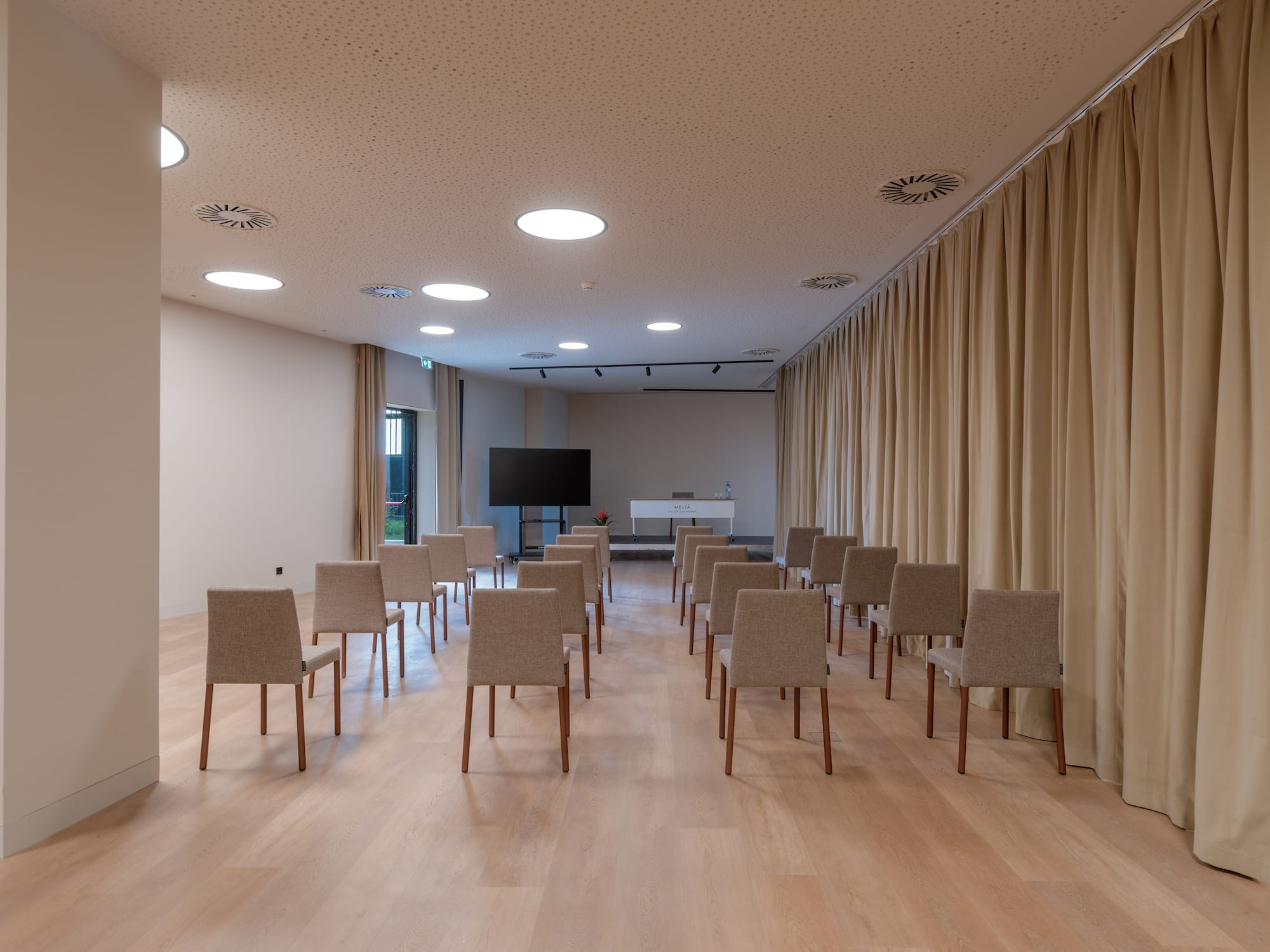 a room with chairs and a television