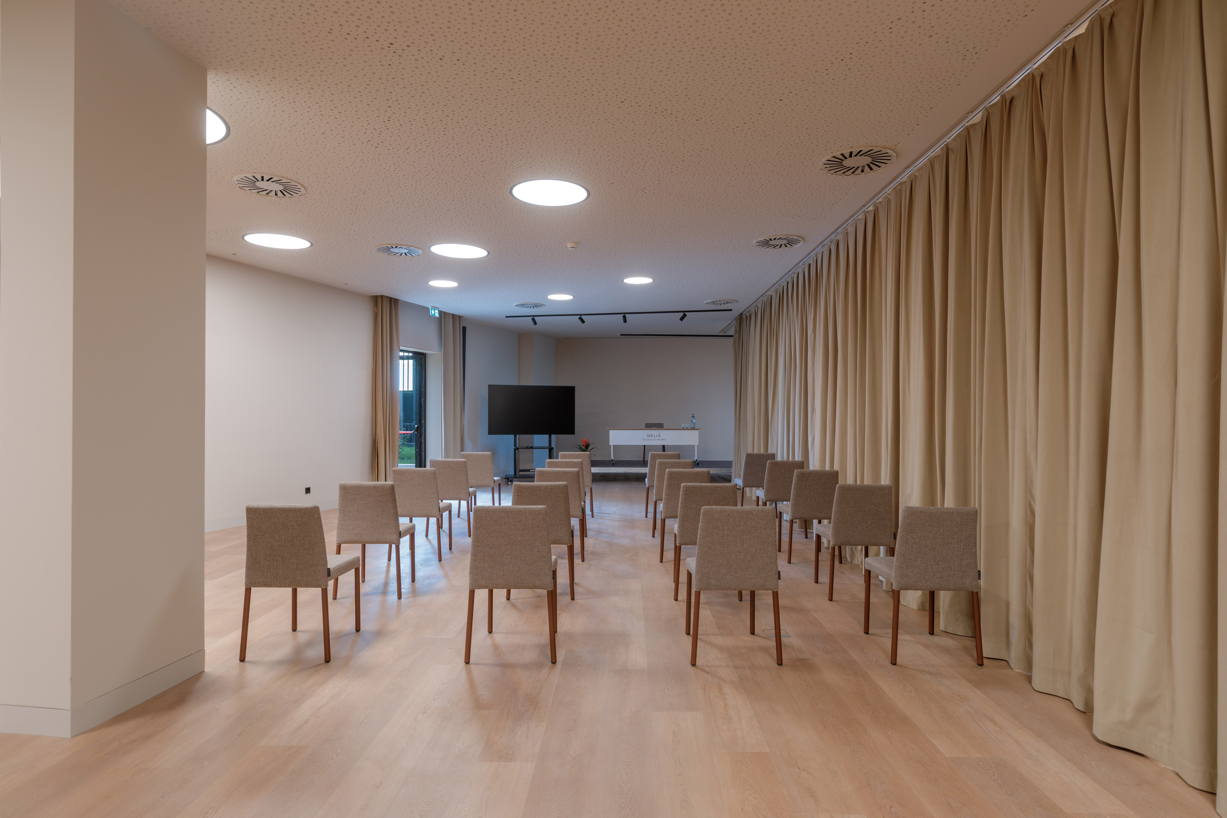 a room with chairs and a television