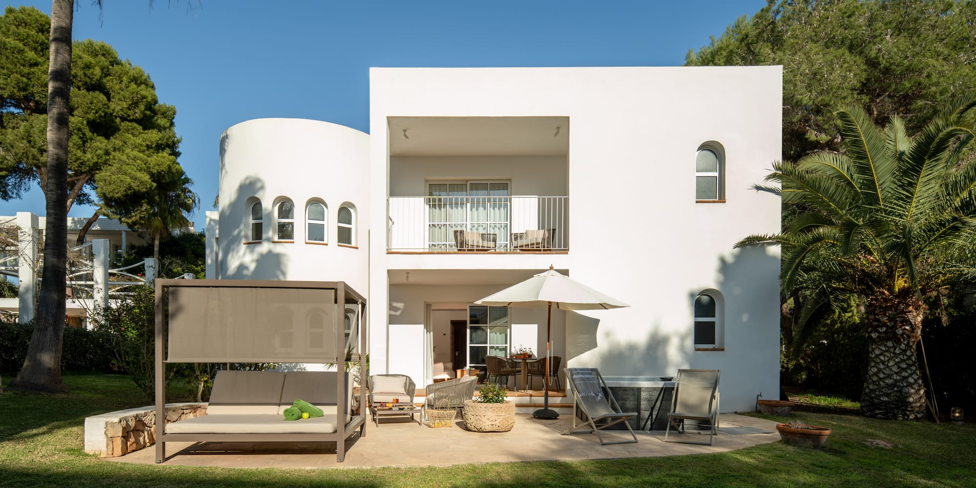 a white house with a patio and chairs