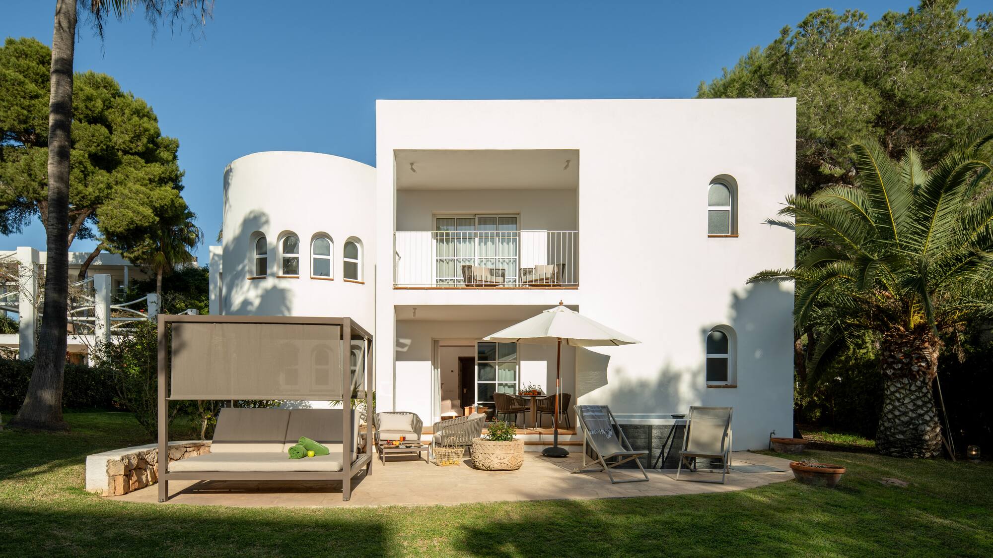 a white house with a patio and chairs