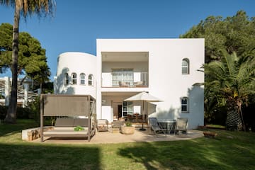 a white house with a patio and chairs