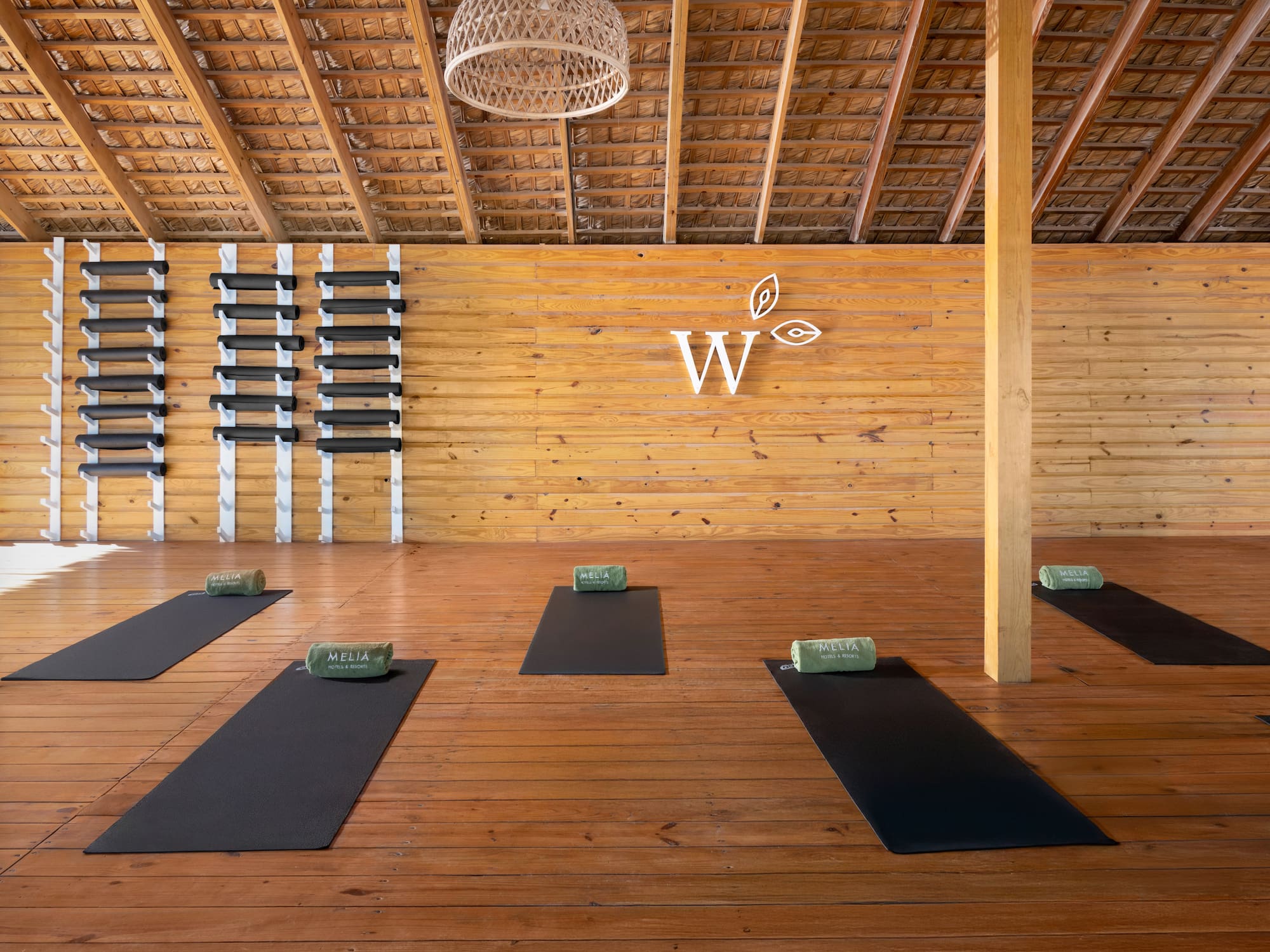 a room with mats and a wall of shelves