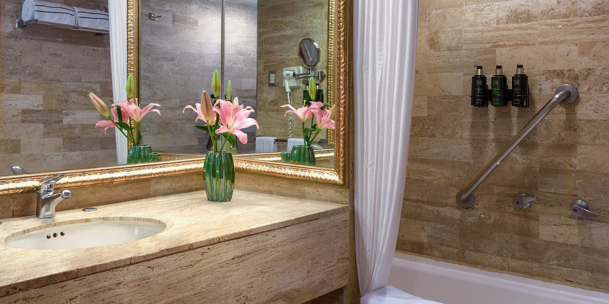 a bathroom with a marble countertop and a sink and a mirror