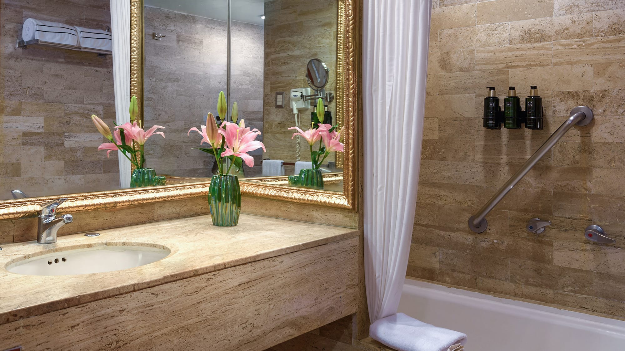 a bathroom with a marble countertop and a sink and a mirror
