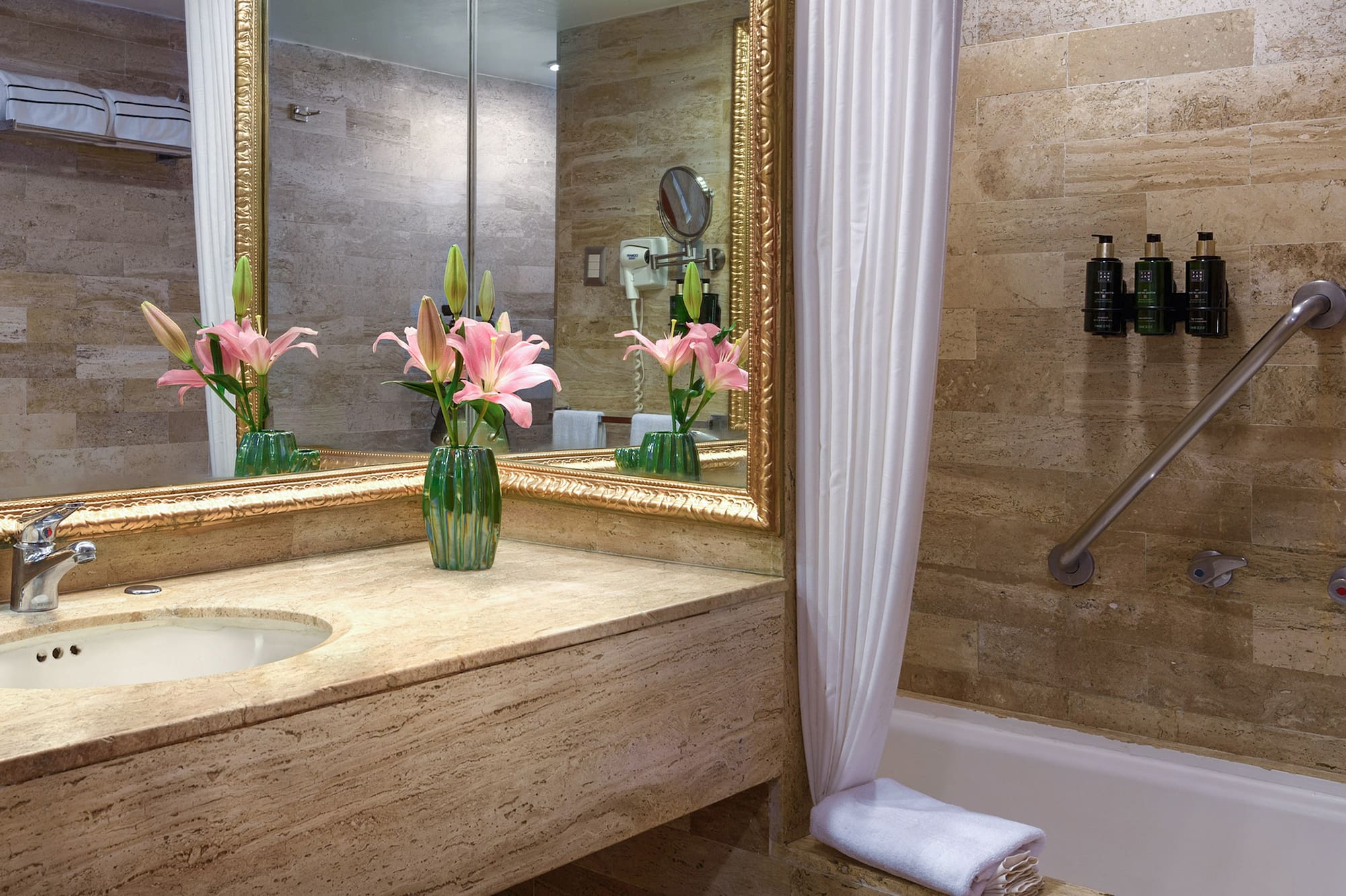 a bathroom with a marble countertop and a sink and a mirror