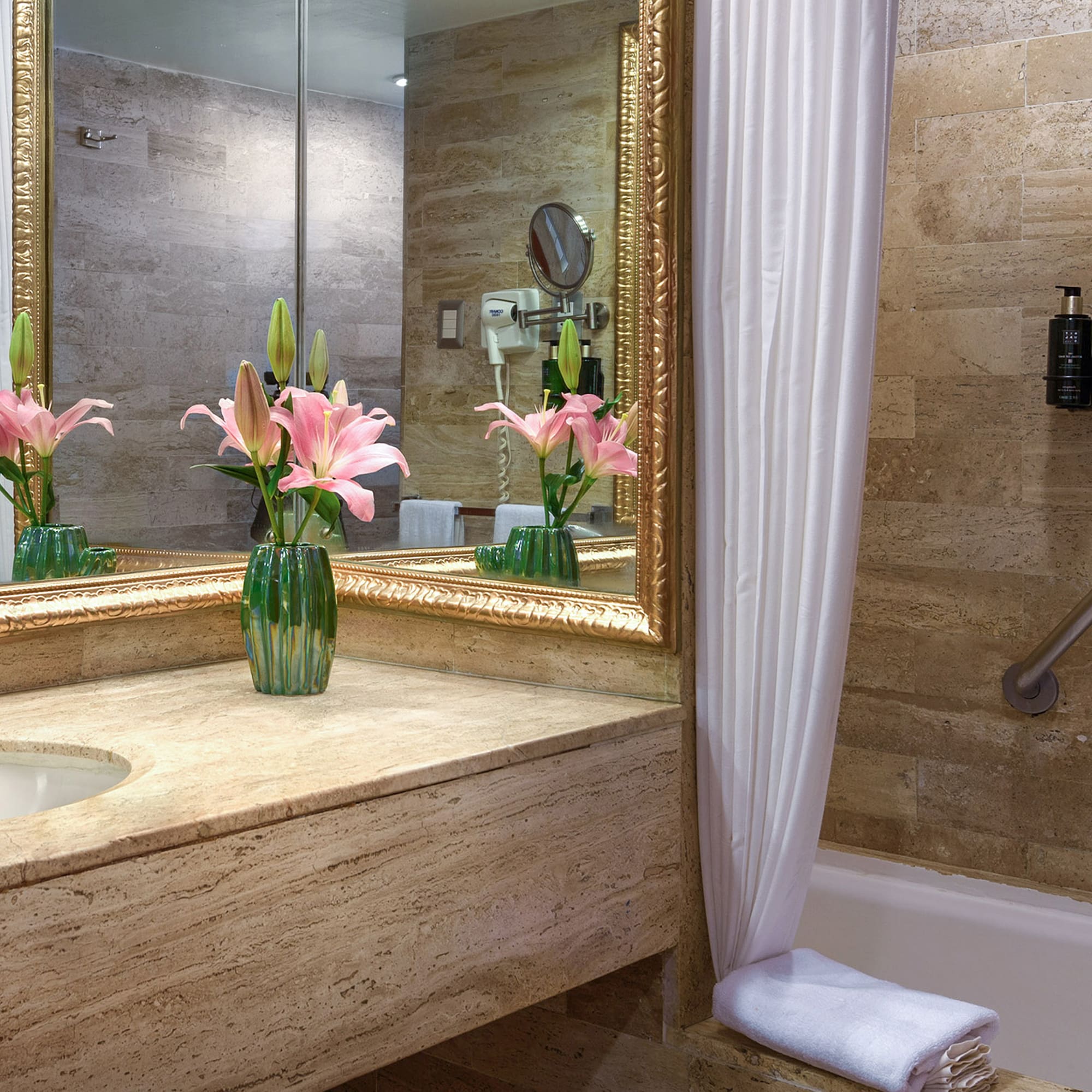 a bathroom with a marble countertop and a sink and a mirror