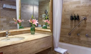 a bathroom with a marble countertop and a sink and a mirror