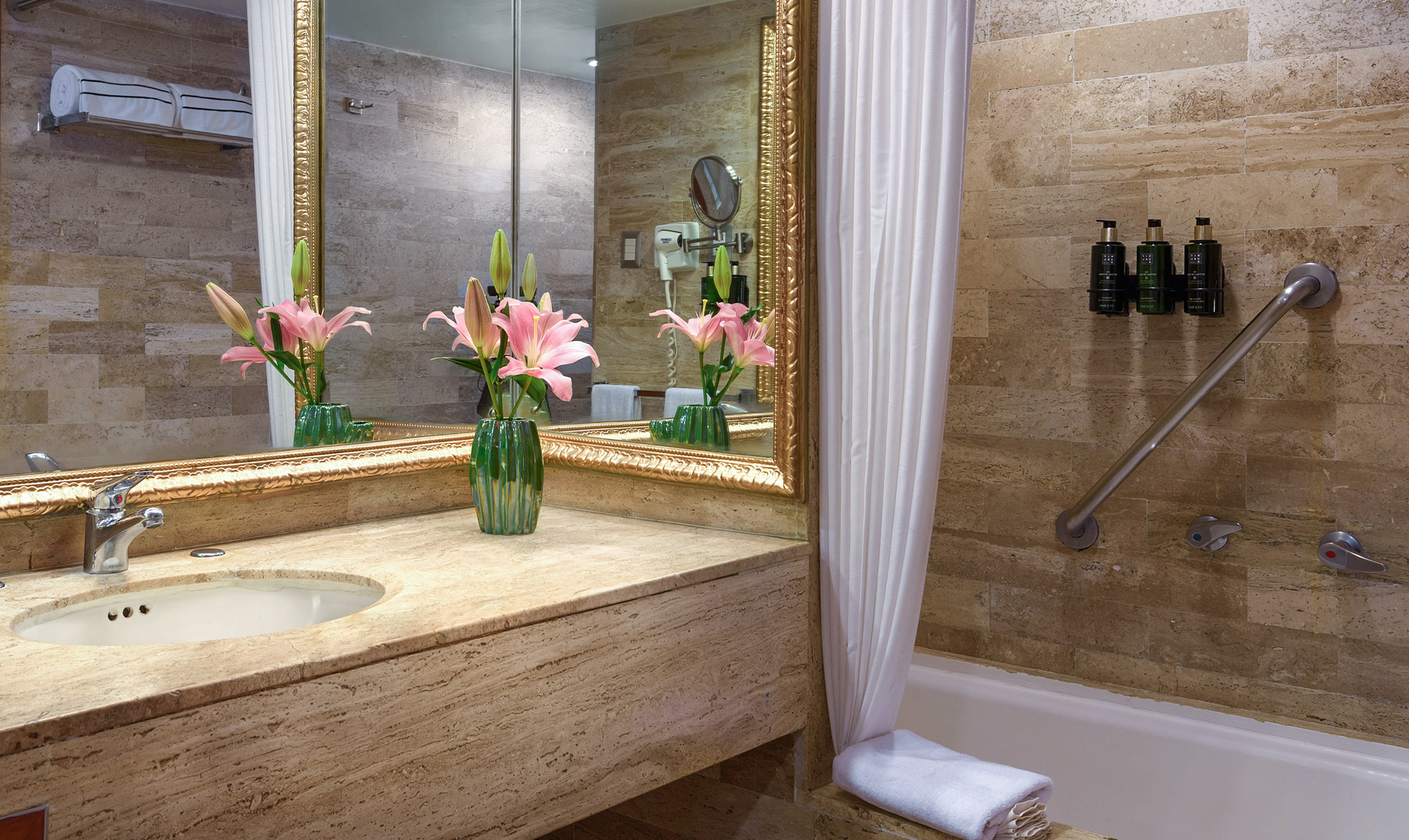 a bathroom with a marble countertop and a sink and a mirror