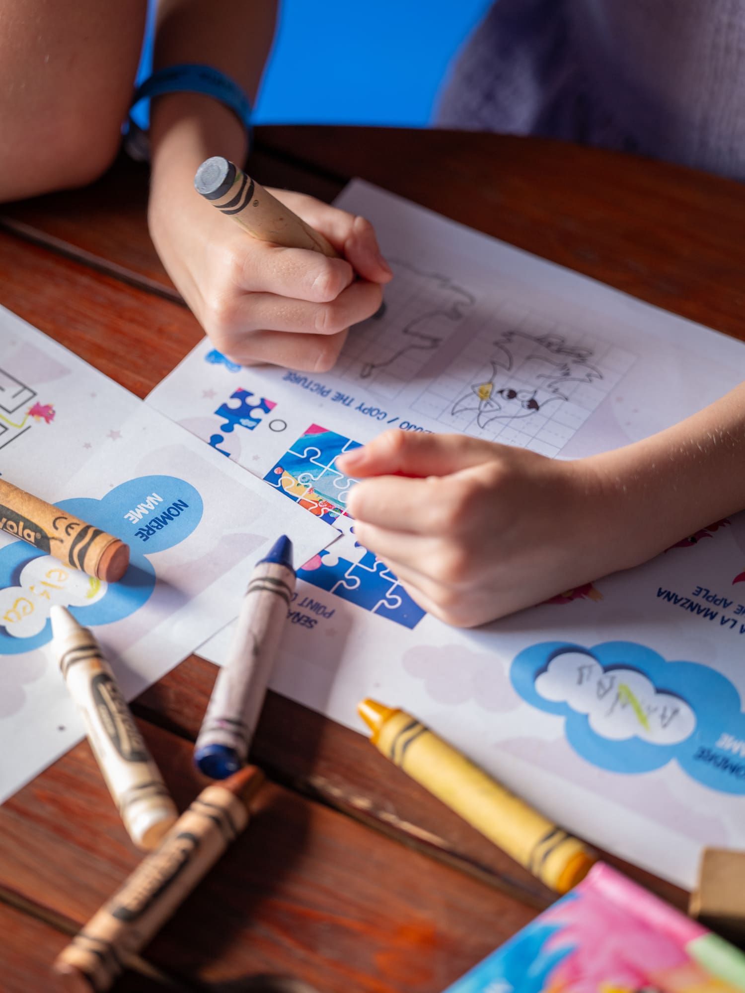 a child coloring on a piece of paper