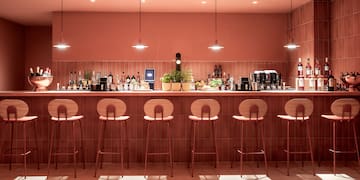 a bar with chairs and lights