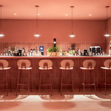 a bar with chairs and lights