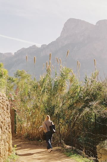 a woman walking in a forest