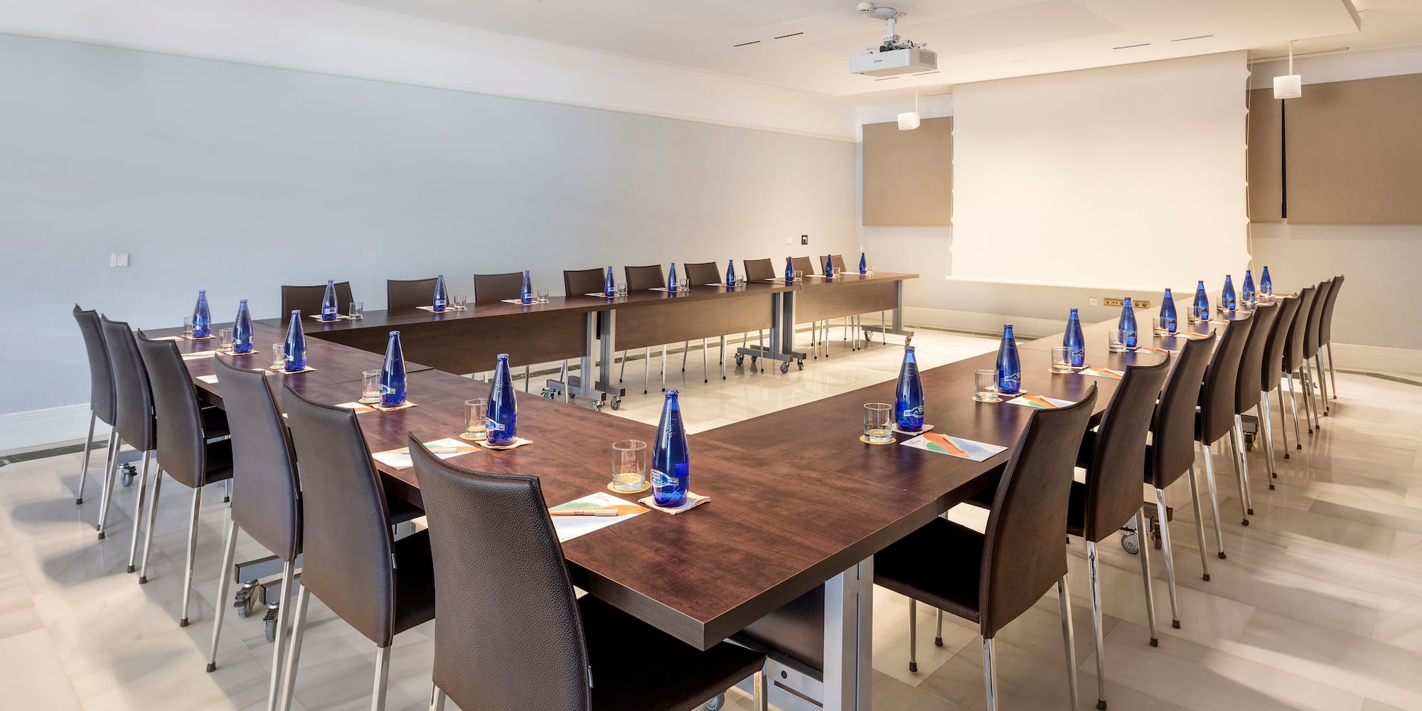a room with a long table and chairs