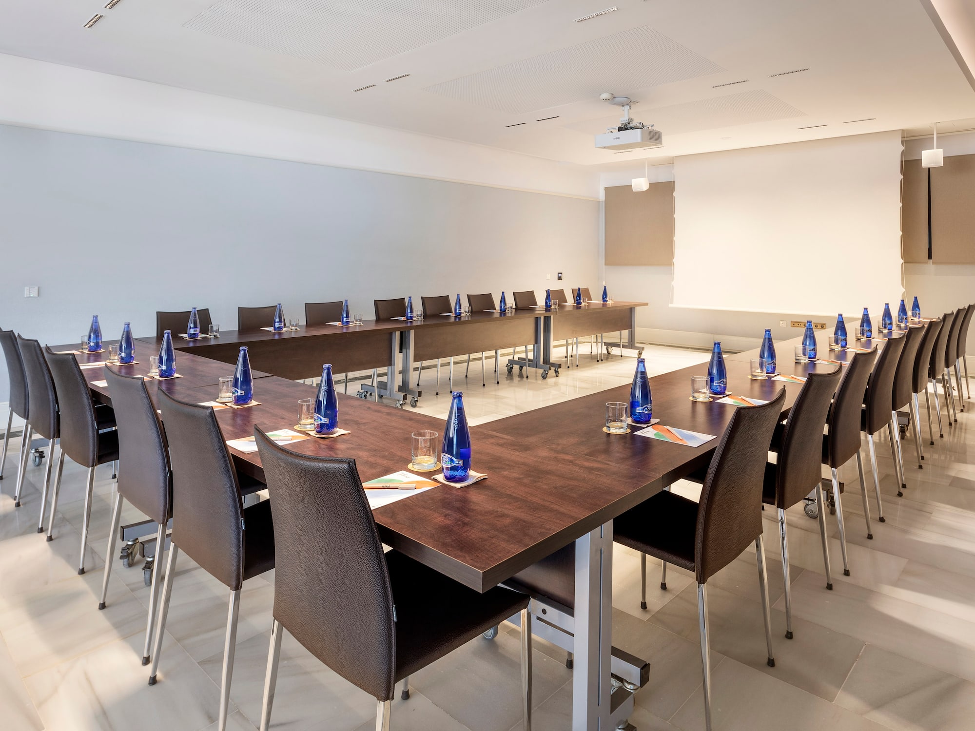 a room with a long table and chairs