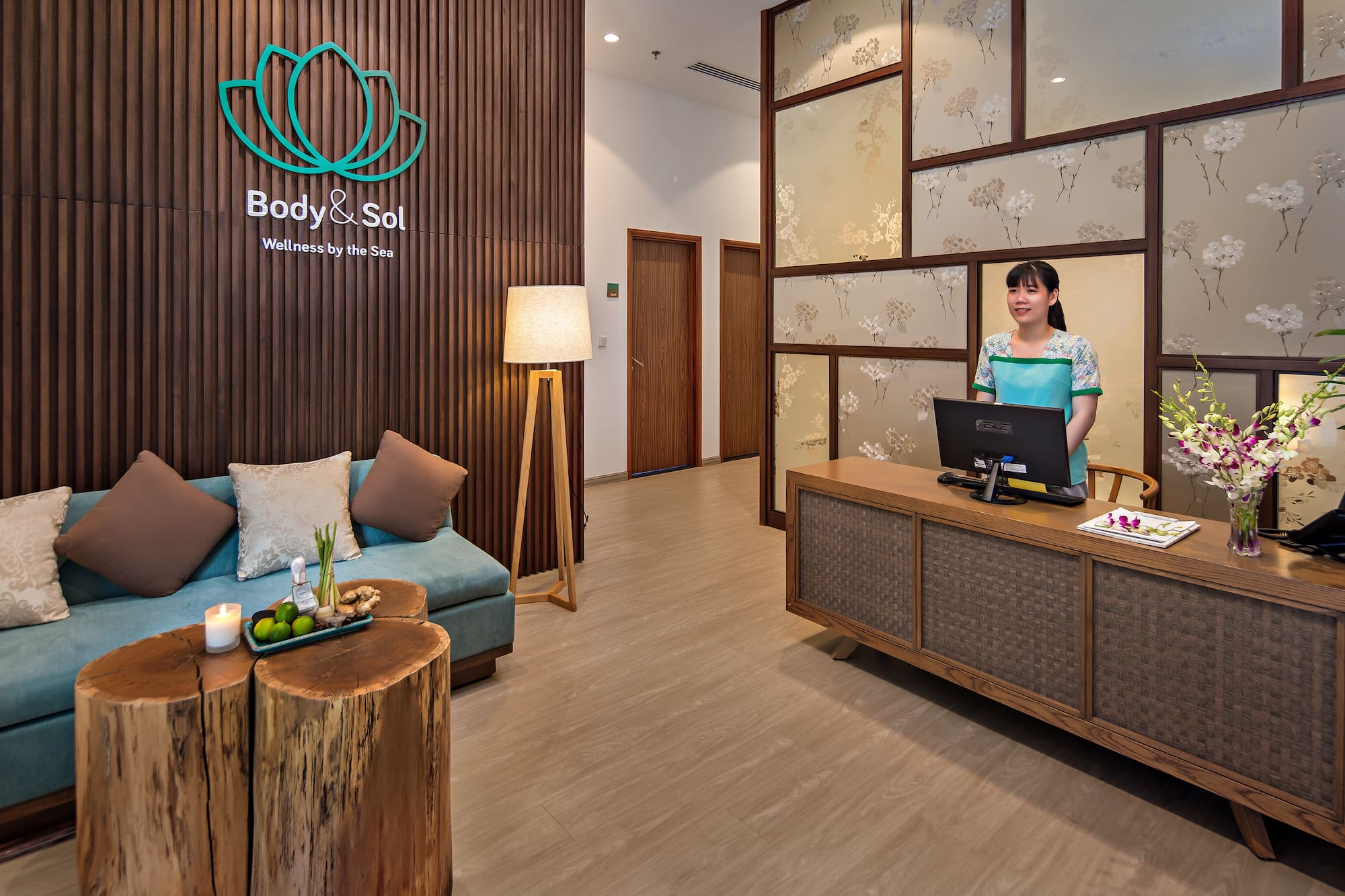 a woman standing behind a desk in a hotel lobby