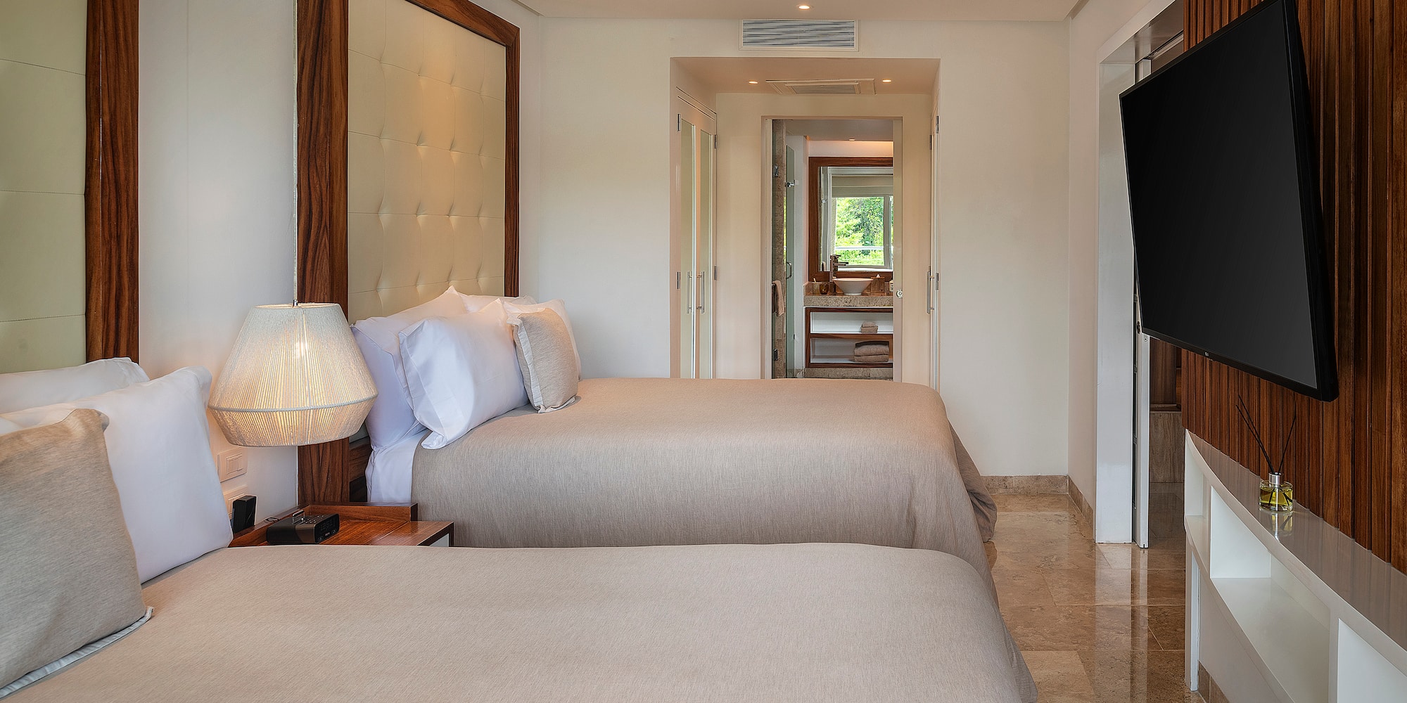 a room with two beds and a television