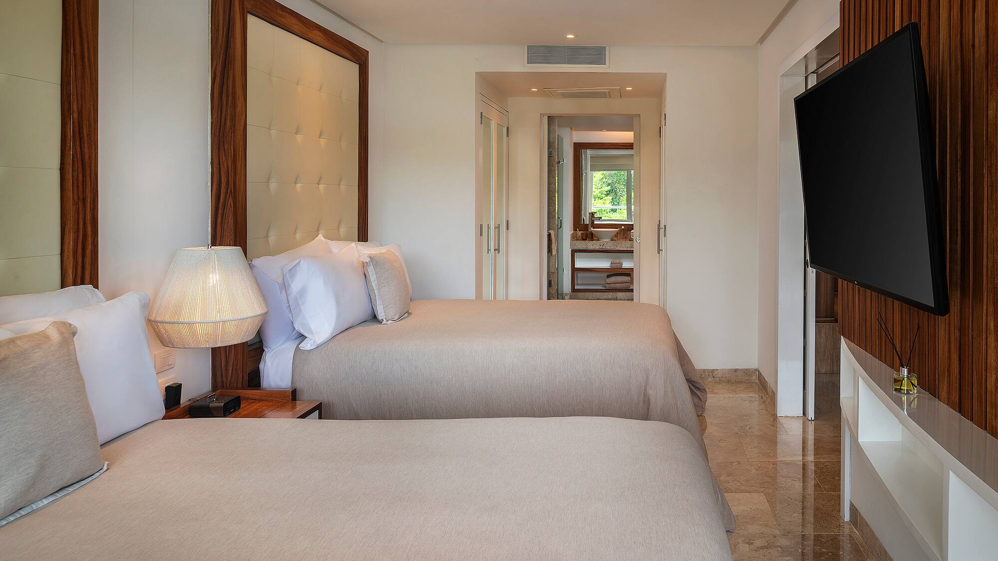 a room with two beds and a television