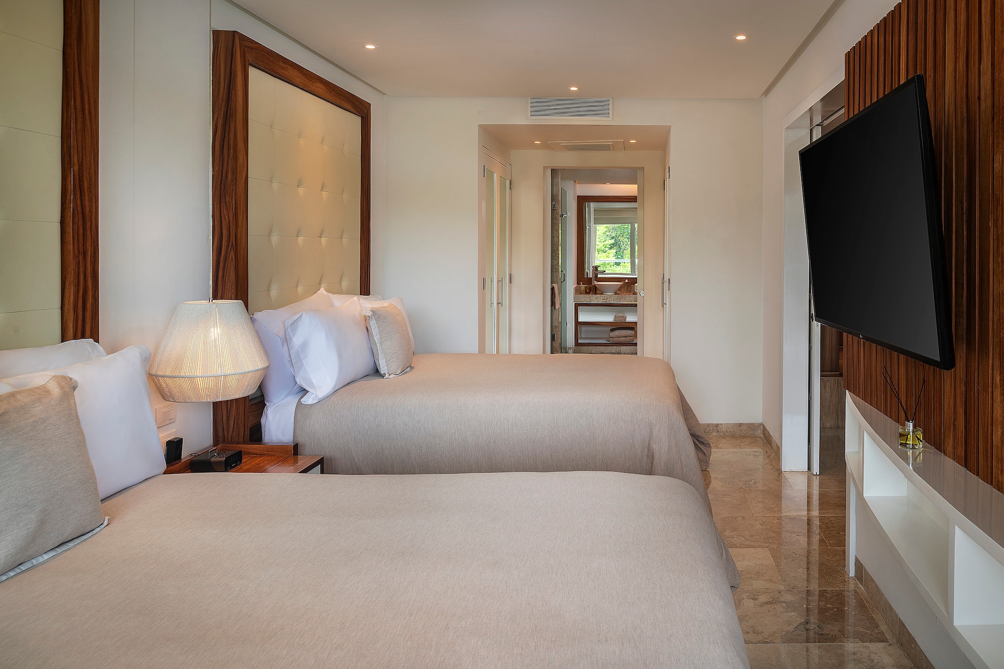 a room with two beds and a television