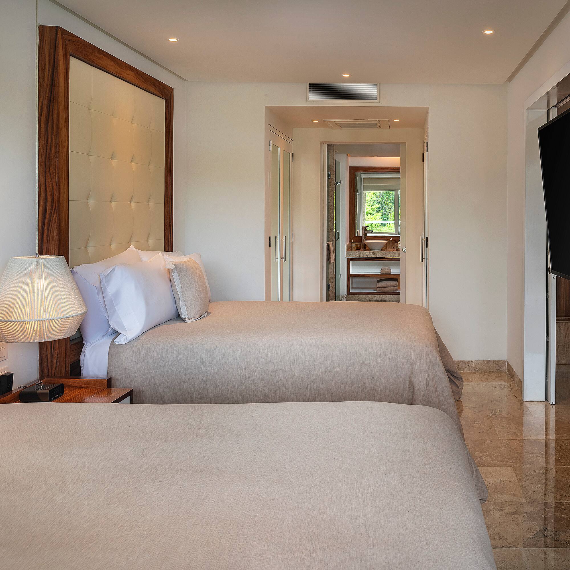 a room with two beds and a television