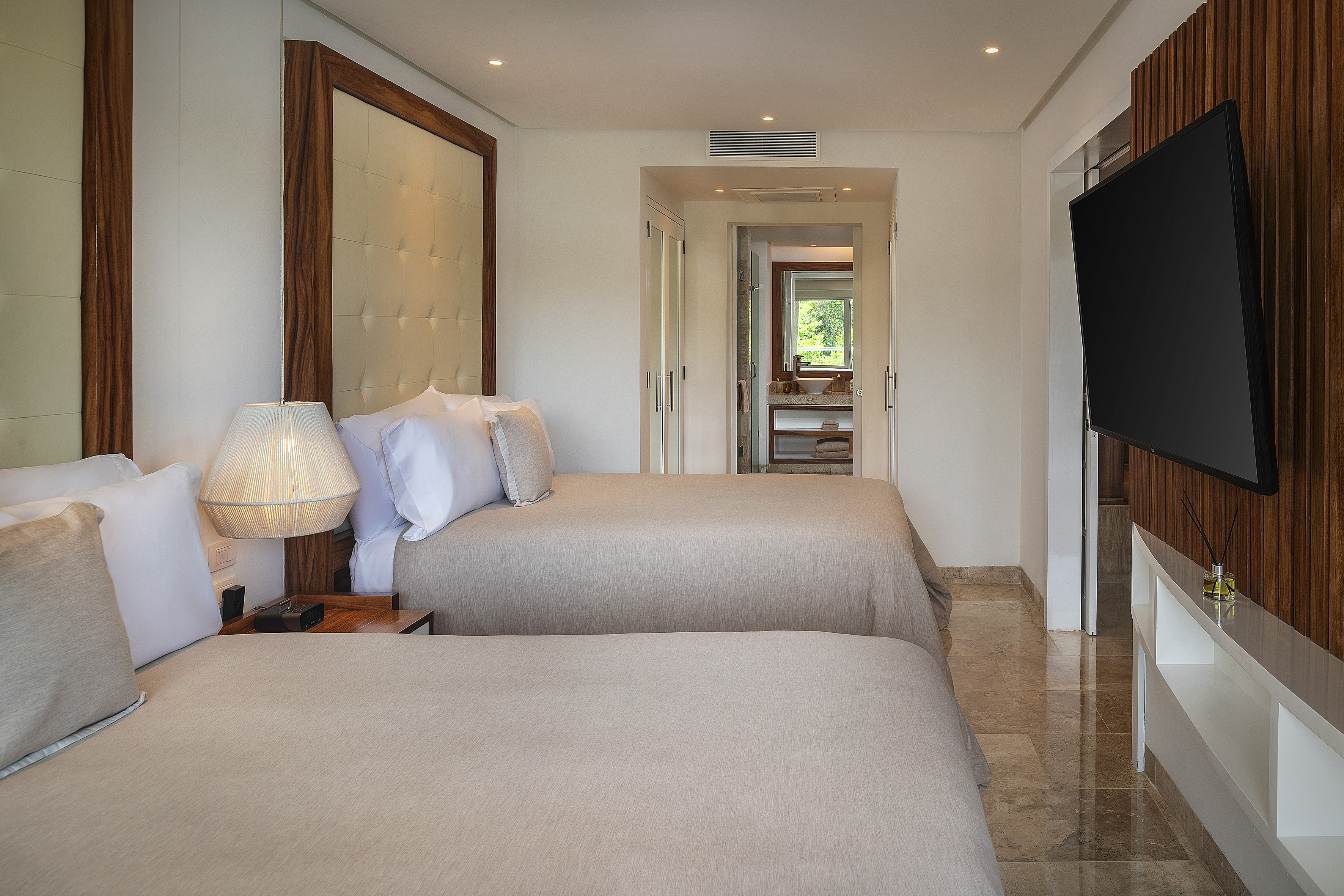 a room with two beds and a television