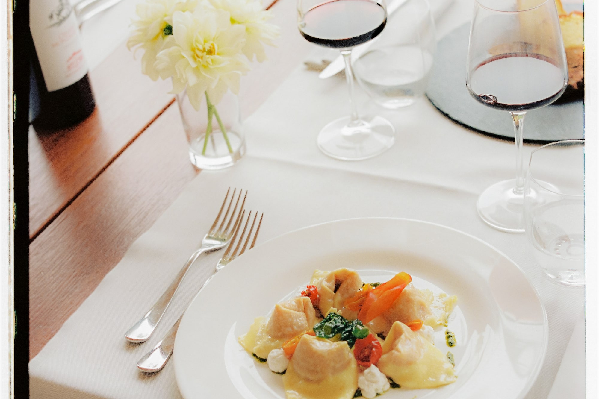 a plate of food and wine glasses on a table