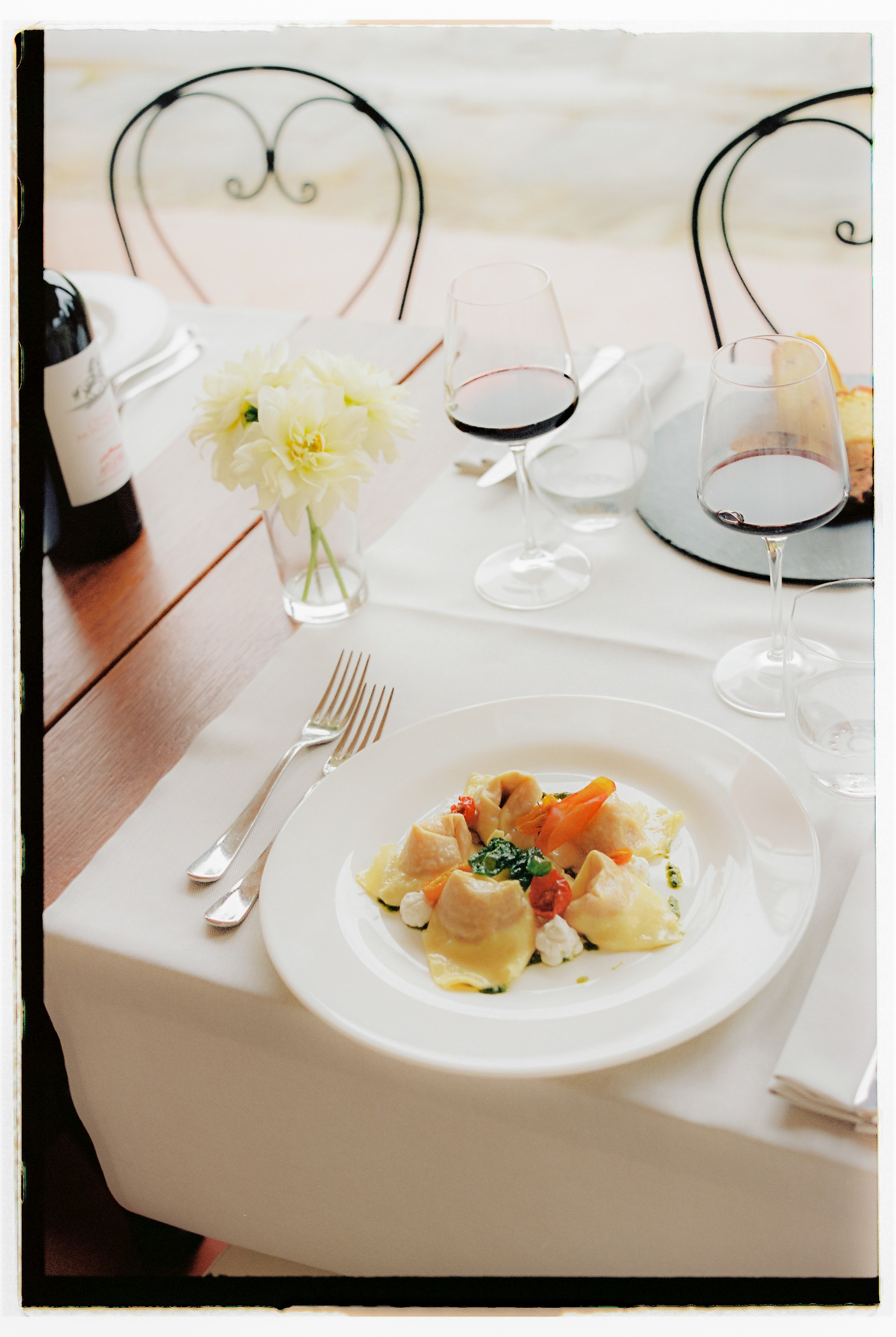 a plate of food and wine glasses on a table