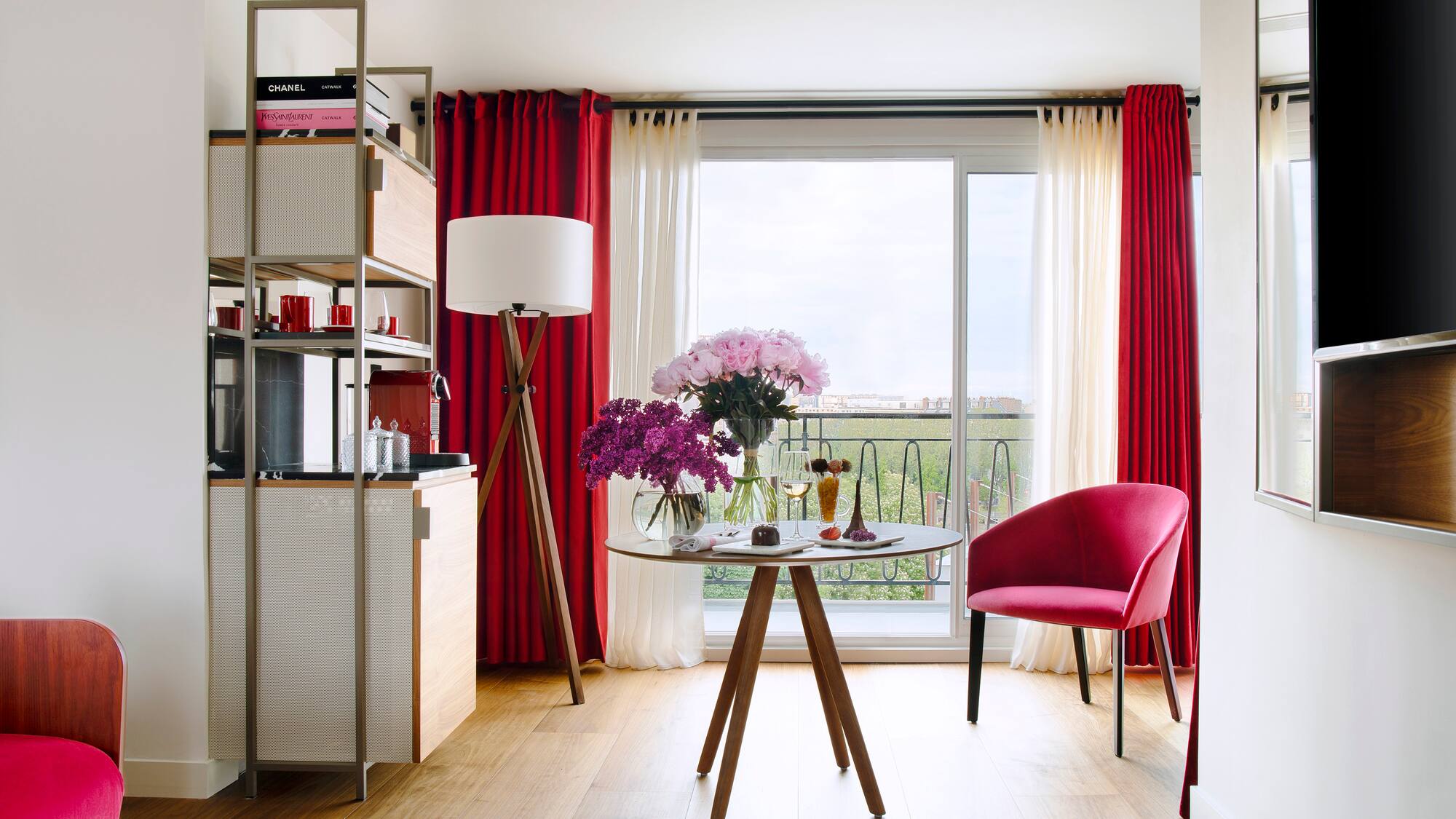 a room with a table and chairs and a window