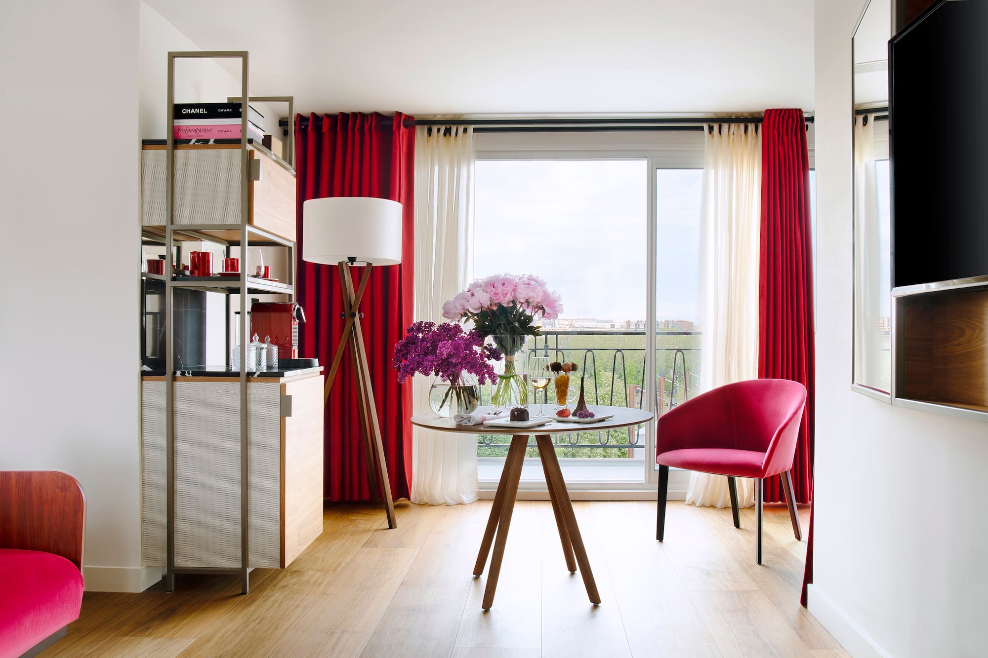 a room with a table and chairs and a window