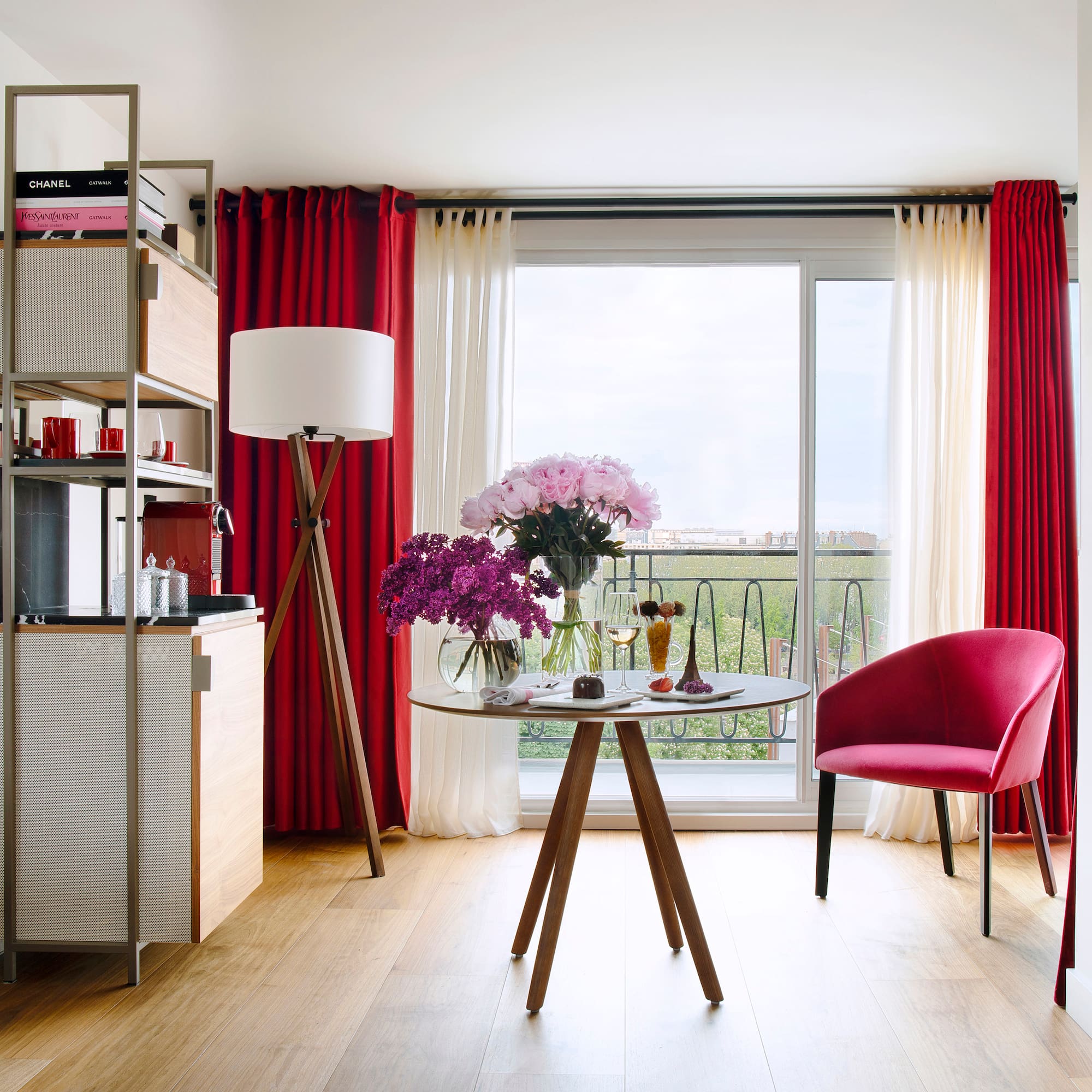 a room with a table and chairs and a window