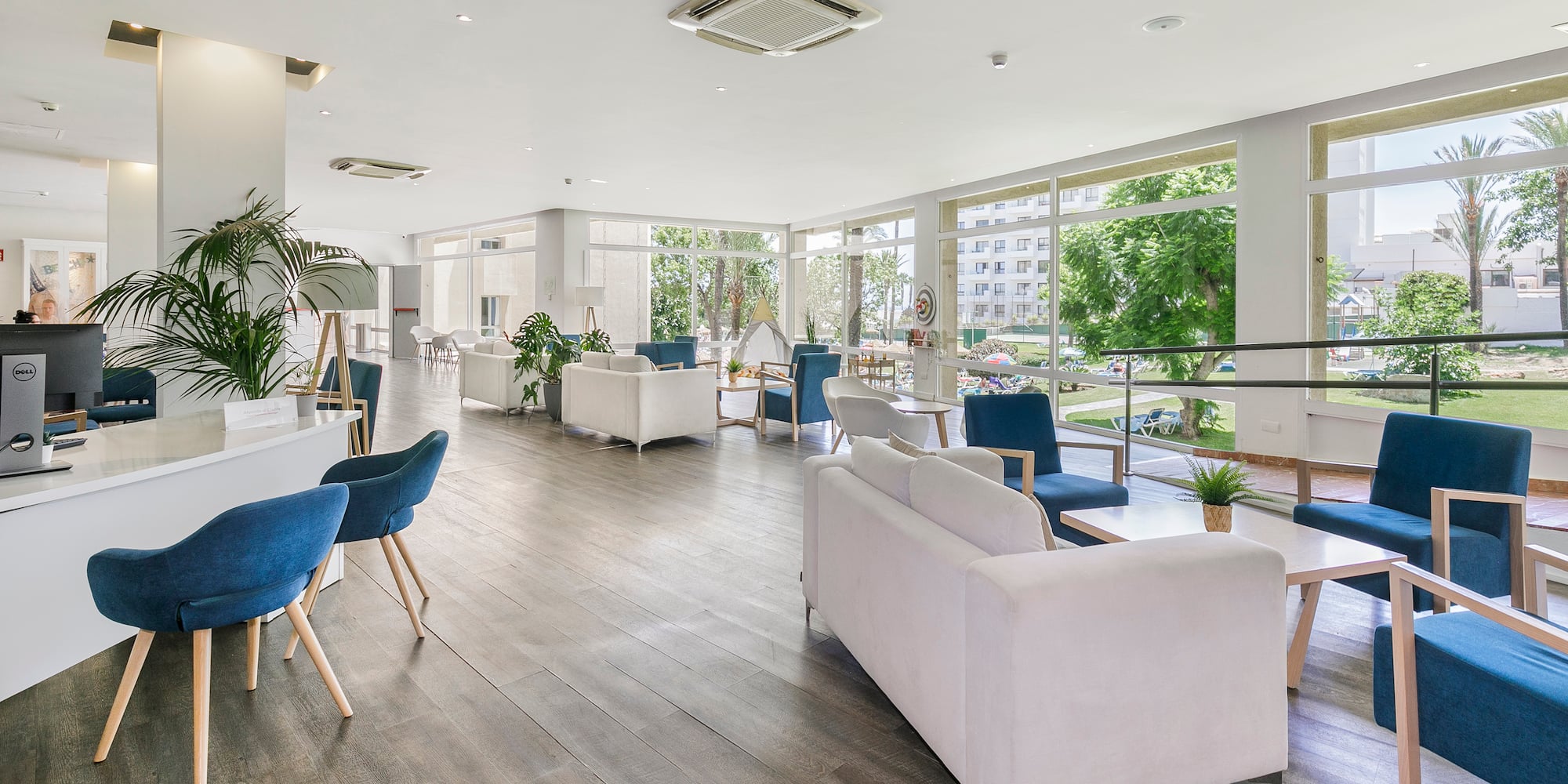 a room with white furniture and blue chairs