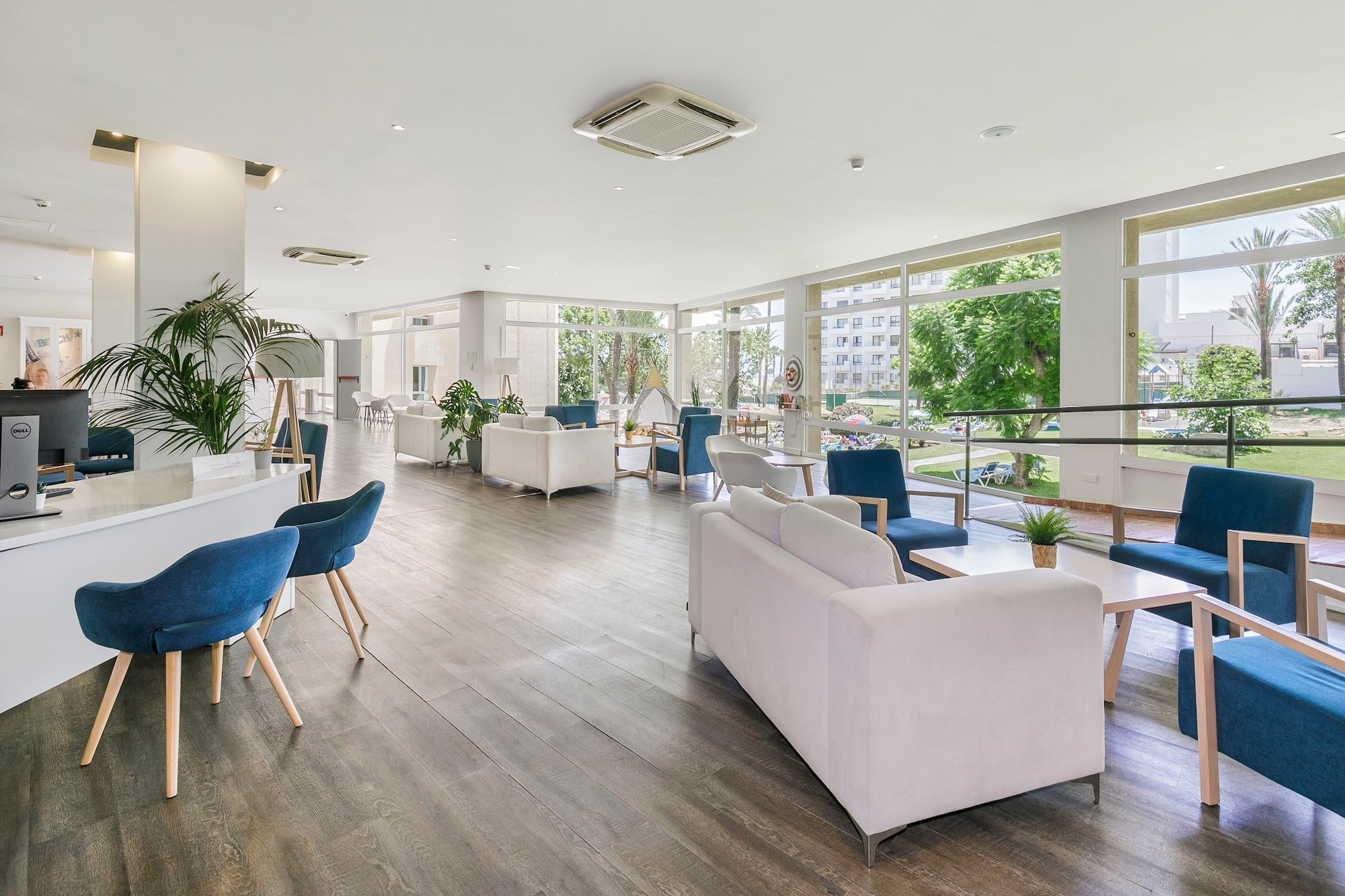a room with white furniture and blue chairs